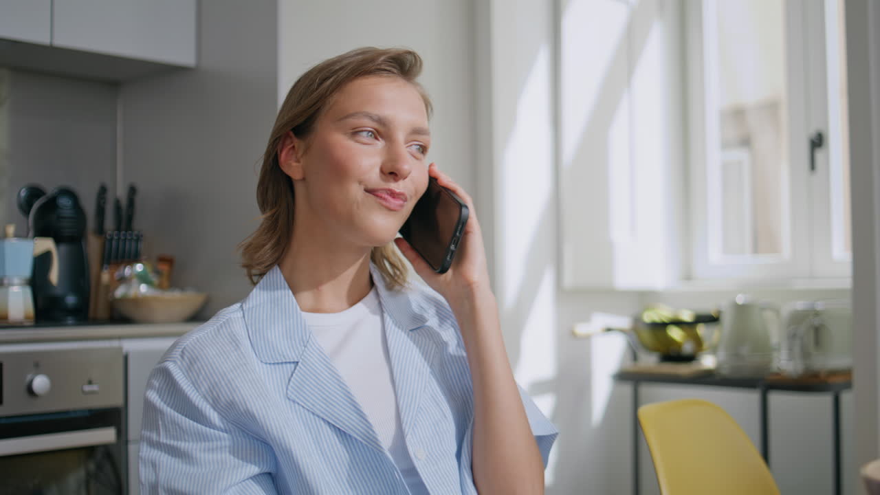 Housewife speaking cellphone morning closeup. Young woman enjoying conversation