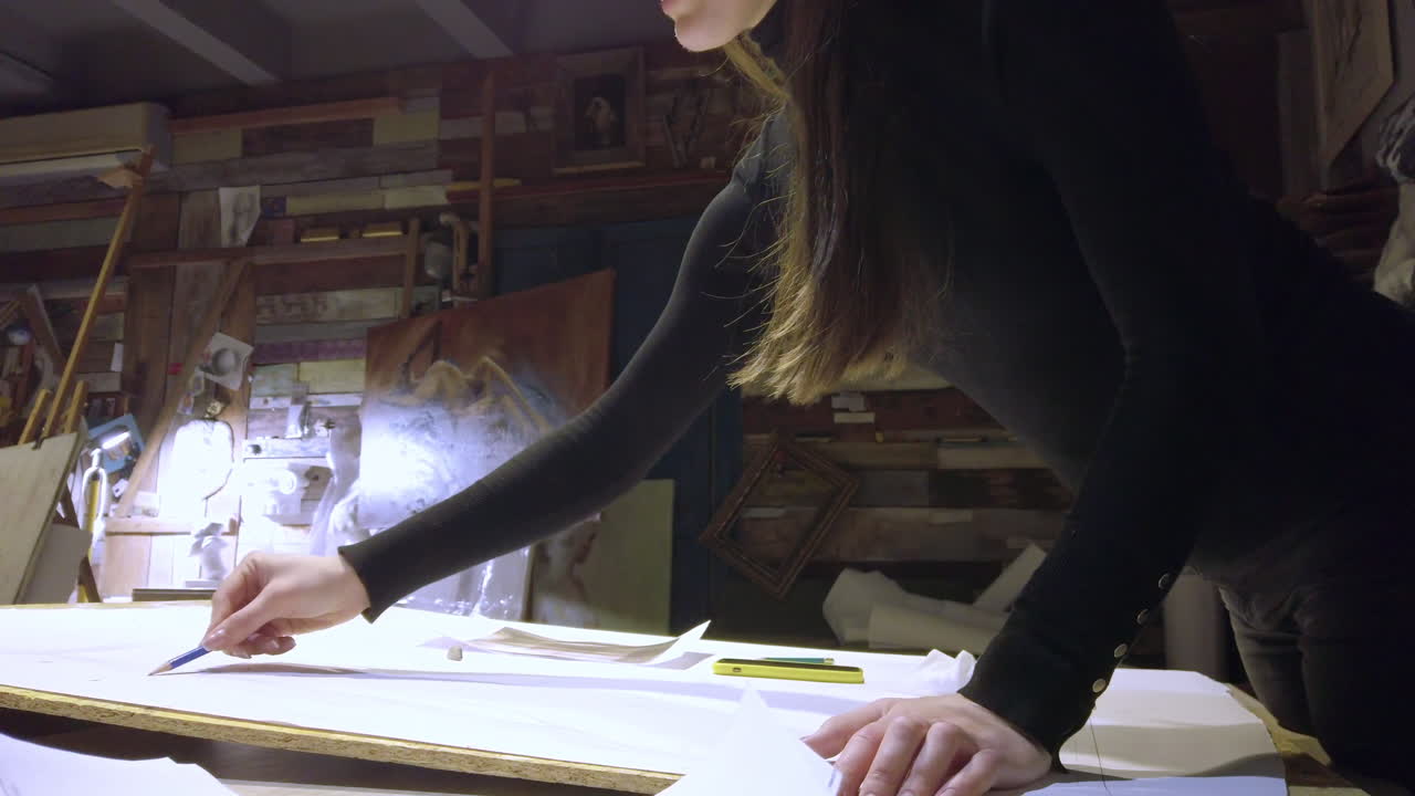 Woman sketching on a canvas at an art gallery workshop