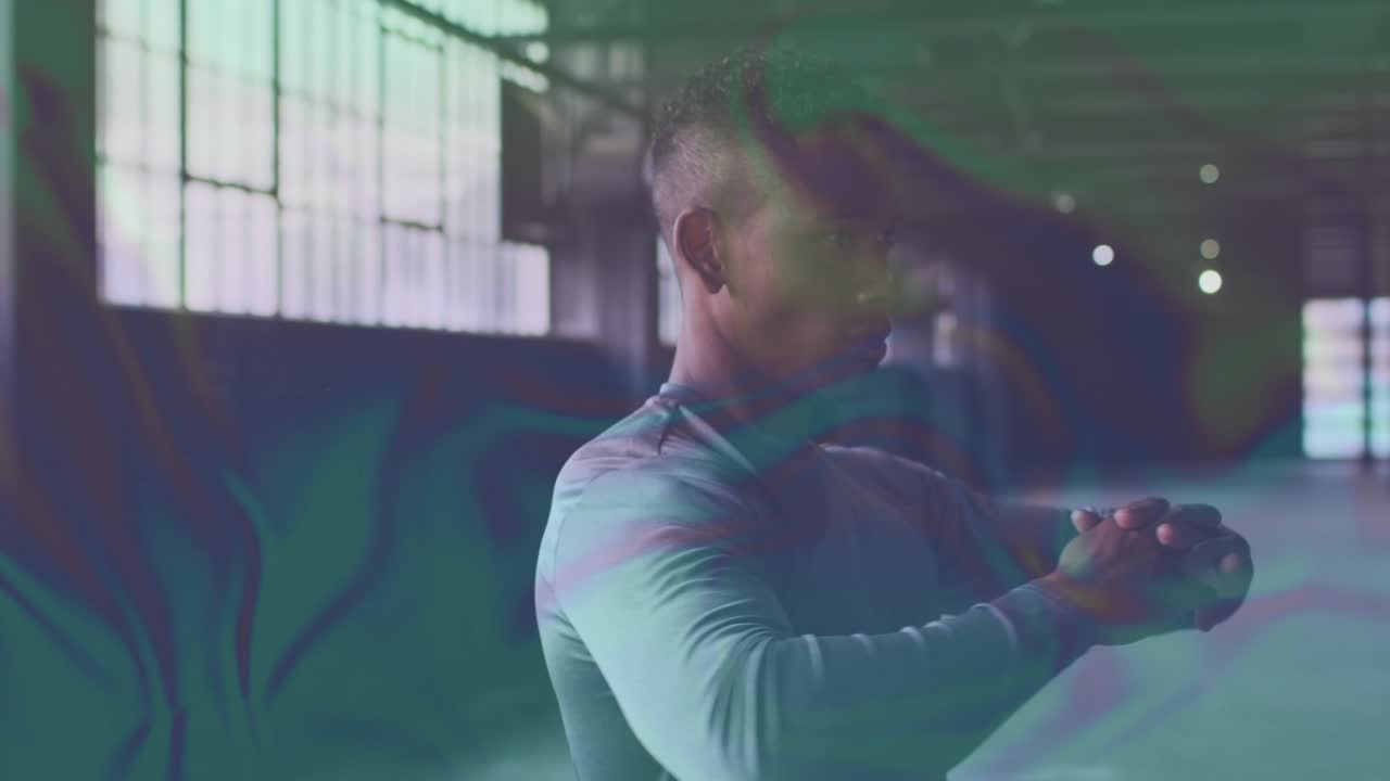 Man starting fit prep by windows, moving crossarm to overhead hold with ripple overlay over subject