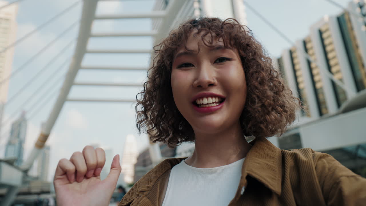 Young Asian Woman Taking Selfie in City