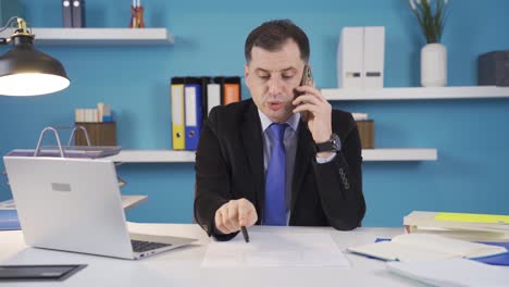 Businessman-working-in-office-making-phone-call-about-business.