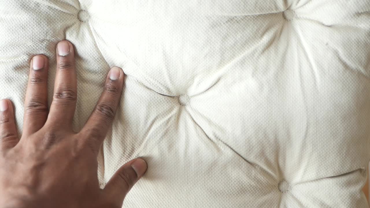 Hand on upholstered fabric