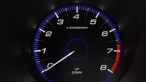 tachometer gauge of starting and stopping car close up