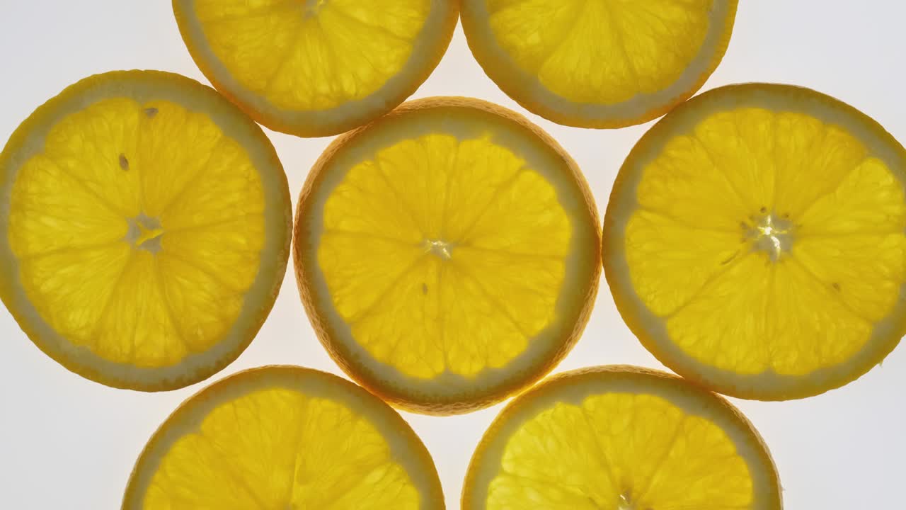 Collection of fresh orange slices on white background. Rotation citrus fruit. Top view.