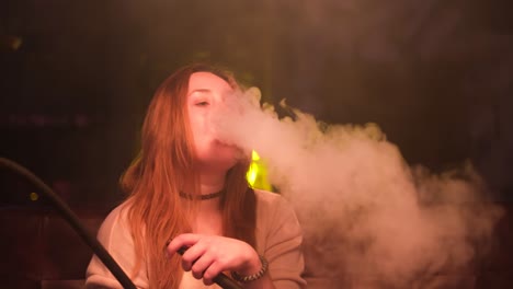 woman smoking hookah in a lounge