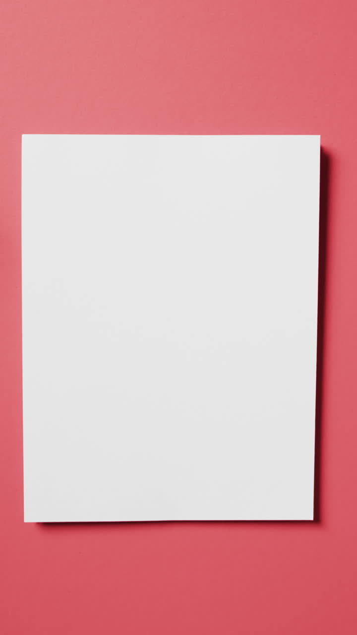 Vertical video of white card with copy space on red background
