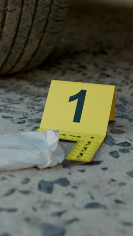 crime scene with evidence bag and yellow marker