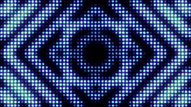 Motivo geometrico pulsante su un'enorme parete di luce