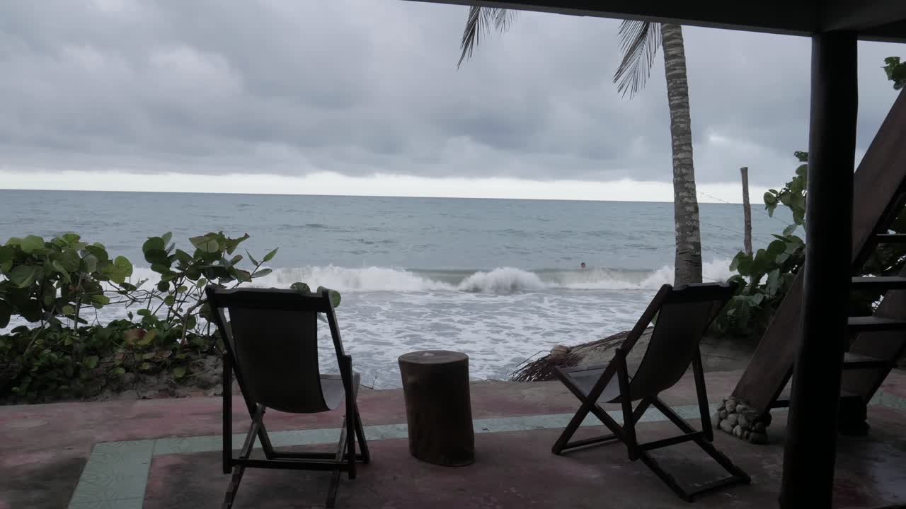 Pan shot of the beach between chairs