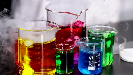 beakers with colorful liquids and dry ice reaction