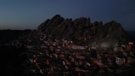 aerial shot of the town of pietrapertosa built under a huge rock massif