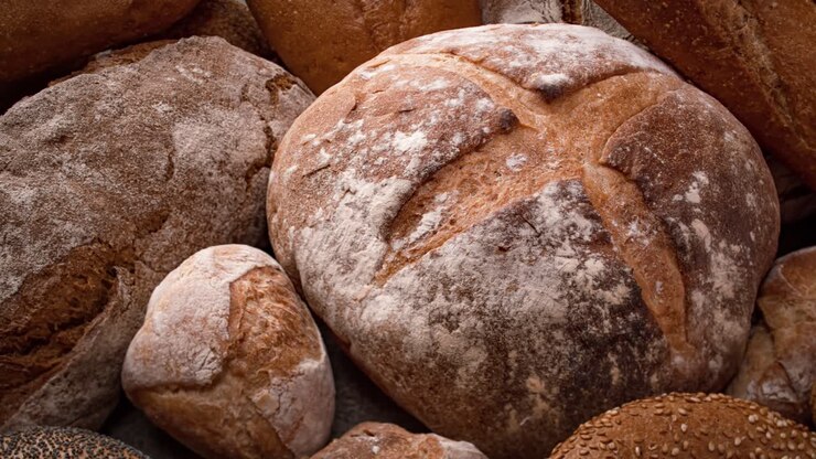 Freshly baked natural bread is on the kitchen table.