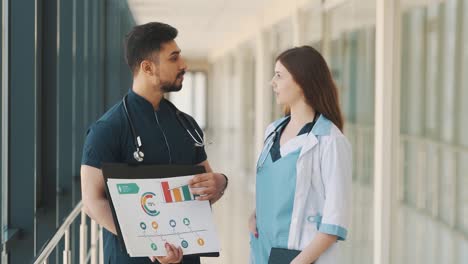 portrait two doctors are conducting an online presentation in a hospital corridor