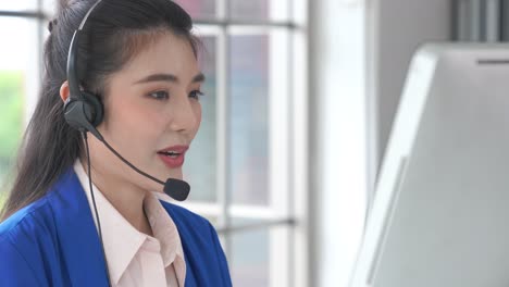 businesswoman wearing headset working actively in office