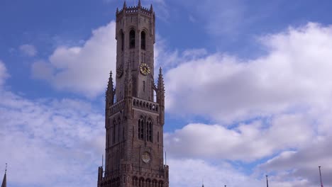 nubes de lapso de tiempo moviéndose detrás del campanario de belfort van brugge brujas en bélgica