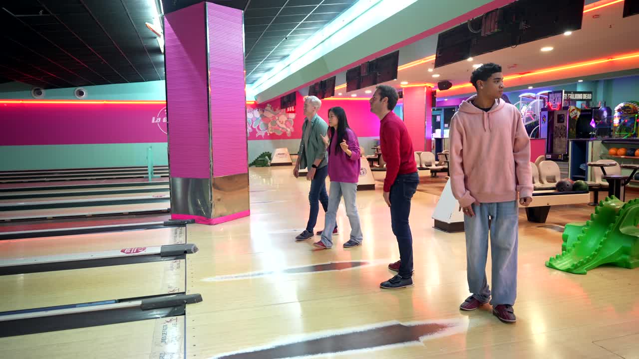People bowling at a bowling alley
