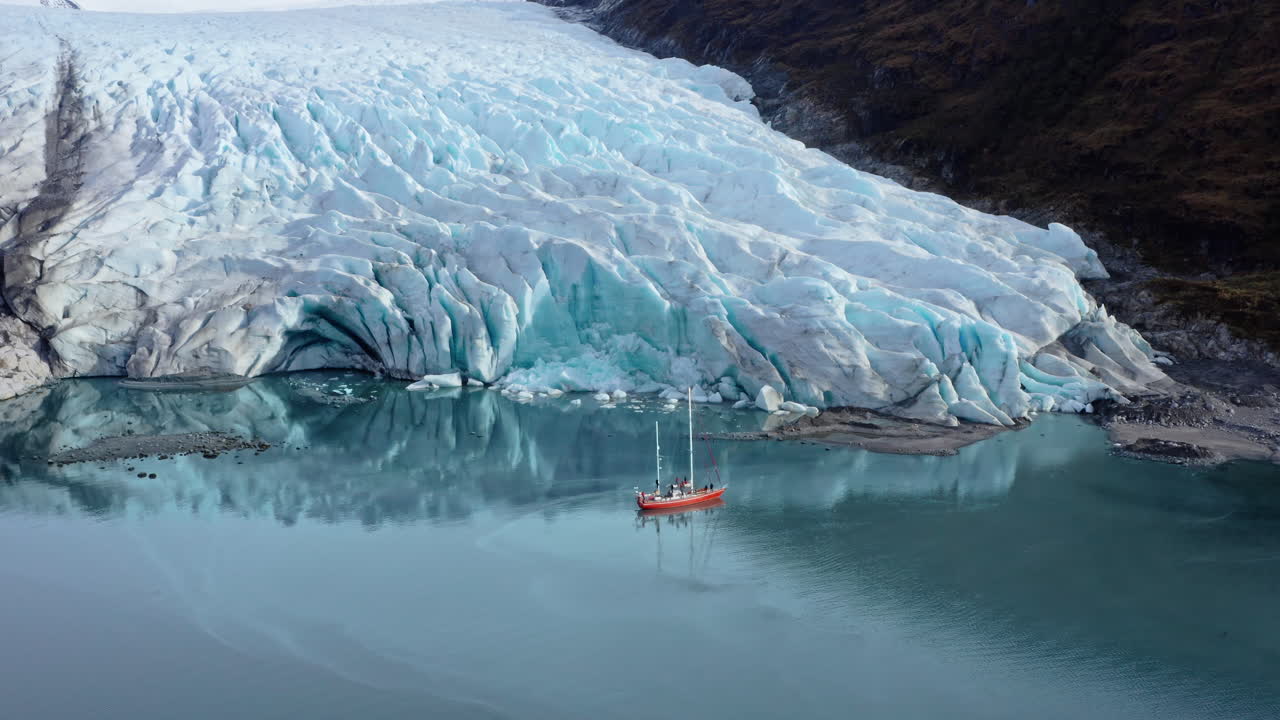 Tourist Boat Exploring Glaciers Along Beagle Channel In Tierra del Fuego, Argentina. Aerial Drone Shot