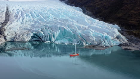 tourist boat exploring glaciers along beagle channel in tierra del fuego, argentina. aerial drone shot
