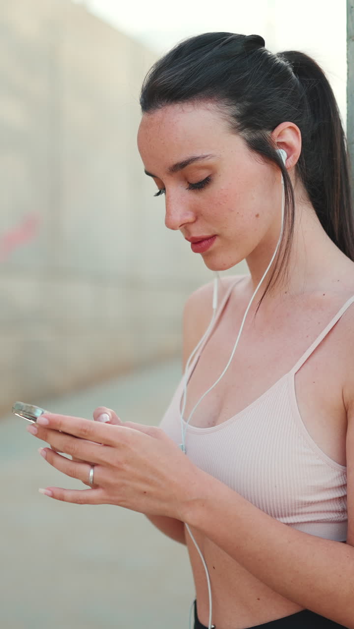 Woman using smartphone with earphones