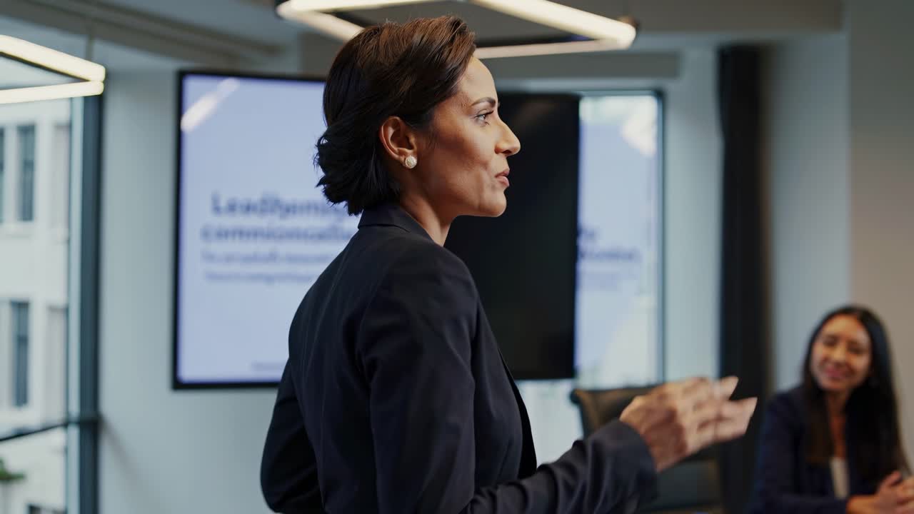 Confident professional woman presenting strategic project, sharing vision and insights with engaged team members in modern, well designed office environment during collaborative meeting