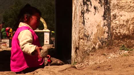 little nepalese girl playing with stone in kathmandu nepal
