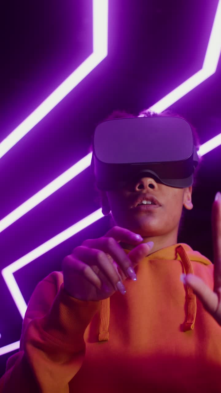 Woman Wearing VR Headset in Neon Lit Room