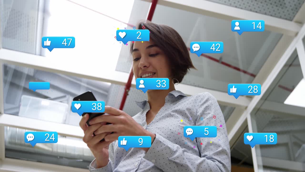 Animation of social media icons with growing numbers over biracial businesswoman using smartphone