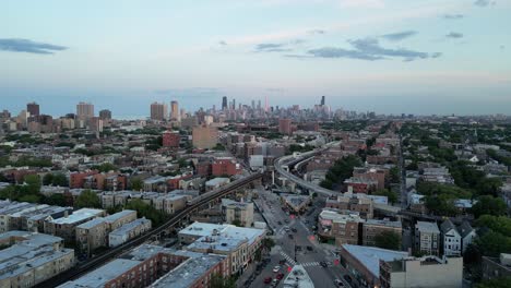 North-Chicago-city-aerial-with-Subway-and-car-traffic-sunset-evening-light-descending-drone-downtown-clark-street-establishing-shot