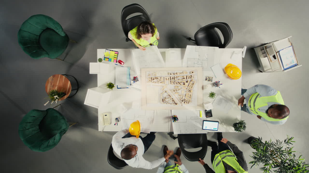 Vertical Video Top down view of development team consulting on real estate investment