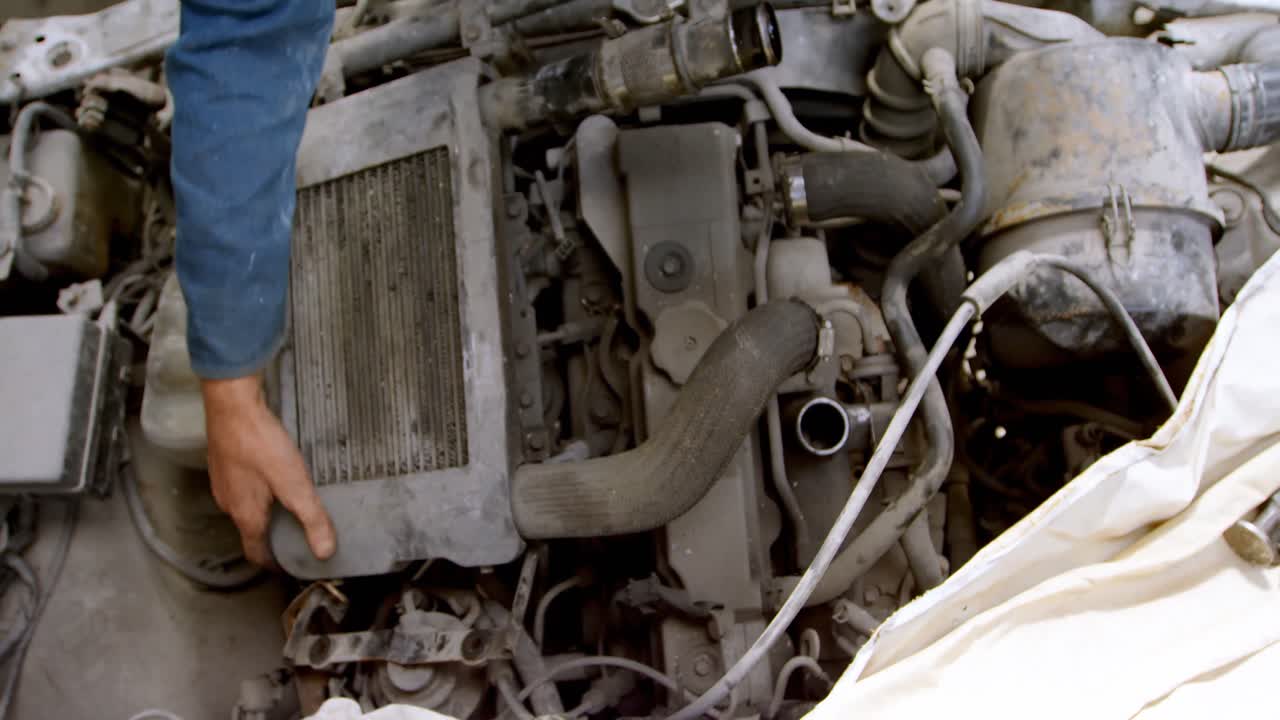 Mechanic fixing a car at repair garage 4k