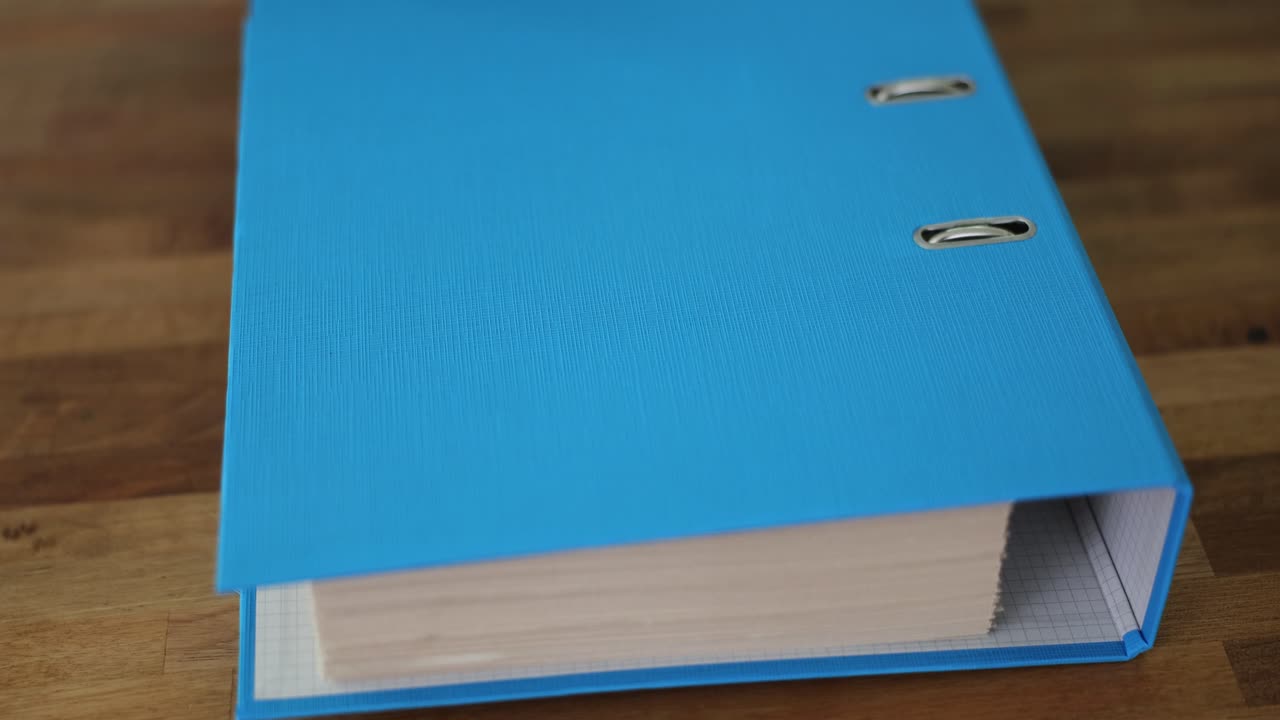 A Combination Lock on a Blue Folder with Documents