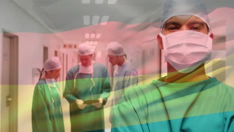 animación de agitar la bandera de alemania sobre un cirujano masculino biracial de pie en el pasillo del hospital
