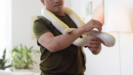 man with snake indoors