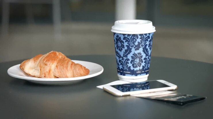 Coffee and croissant on table