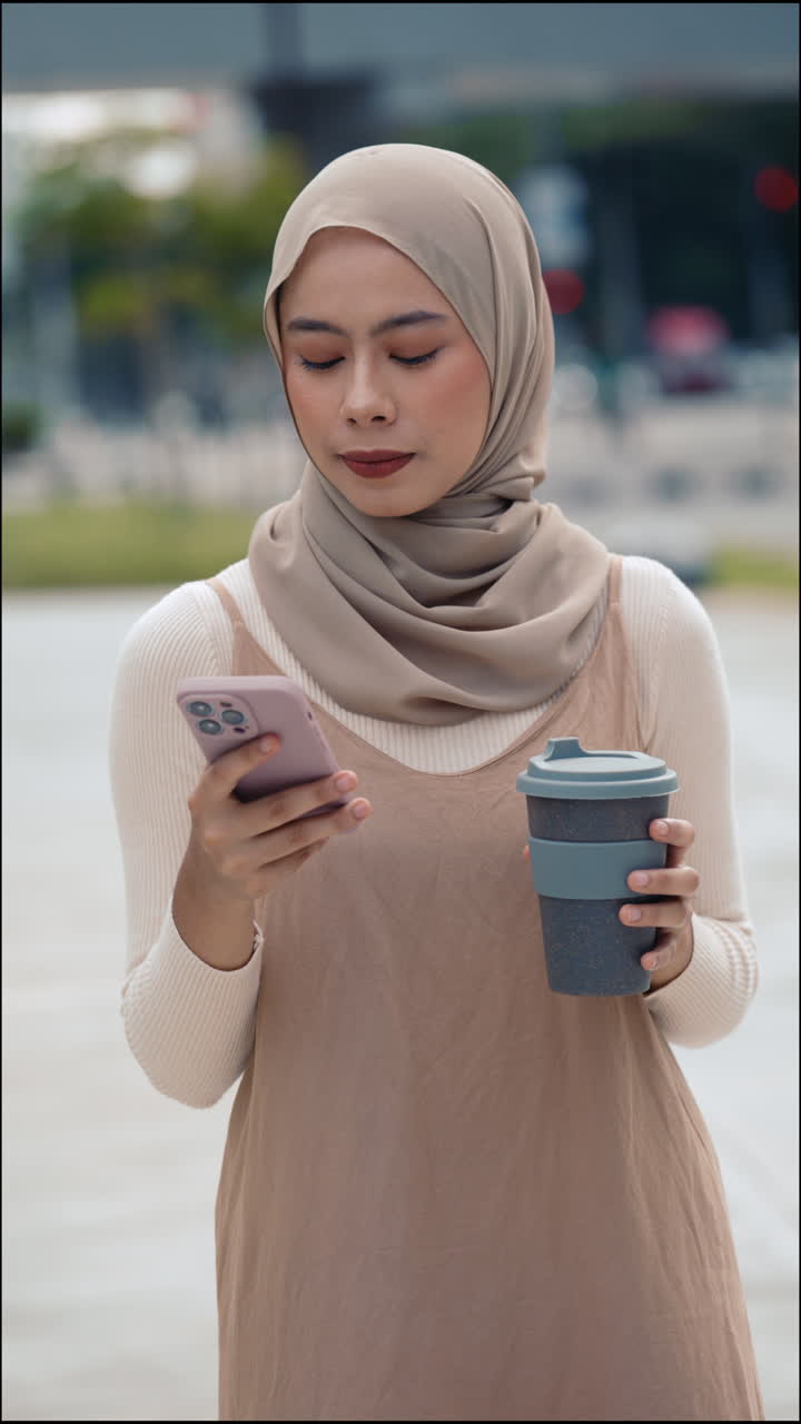 Woman in Hijab with Phone and Coffee