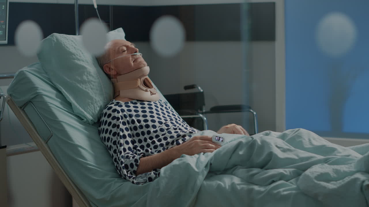 Elder patient recovering after surgery in hospital ward bed