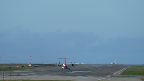 view of vancouver airport runway, regional turboprop plane taking off