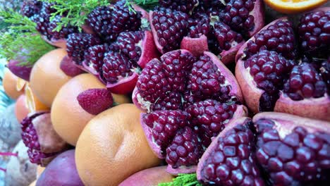 close-up of fresh pomegranates and citrus fruits