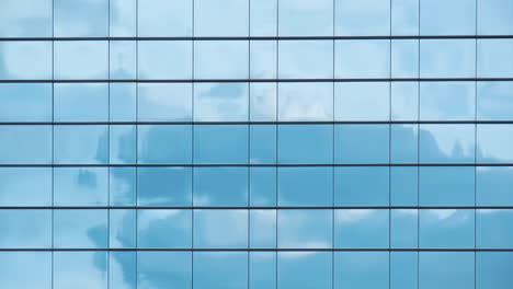 time lapse of blue sky and clouds reflected in structural modular glass wall