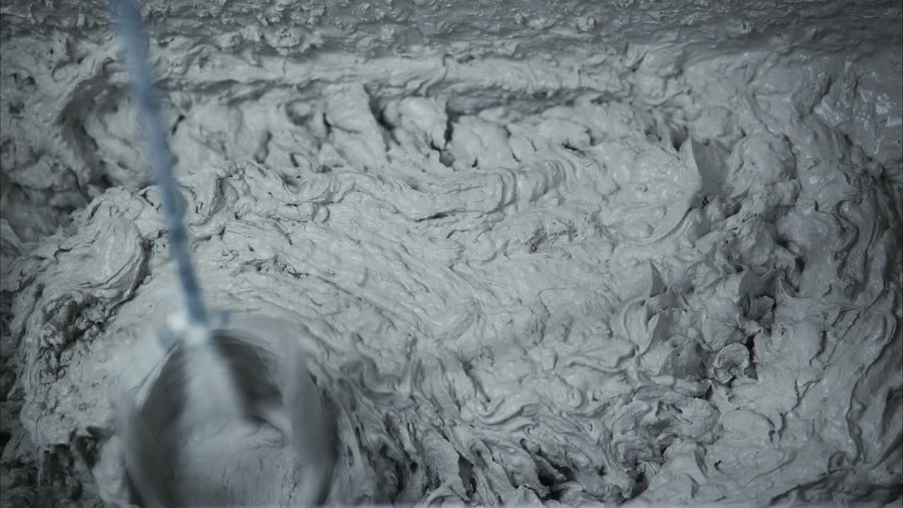 A Close-Up Perspective of Mixing Concrete: The Fluid Dynamics and Texture of Freshly Prepared Cement Mixture in a Construction Setting