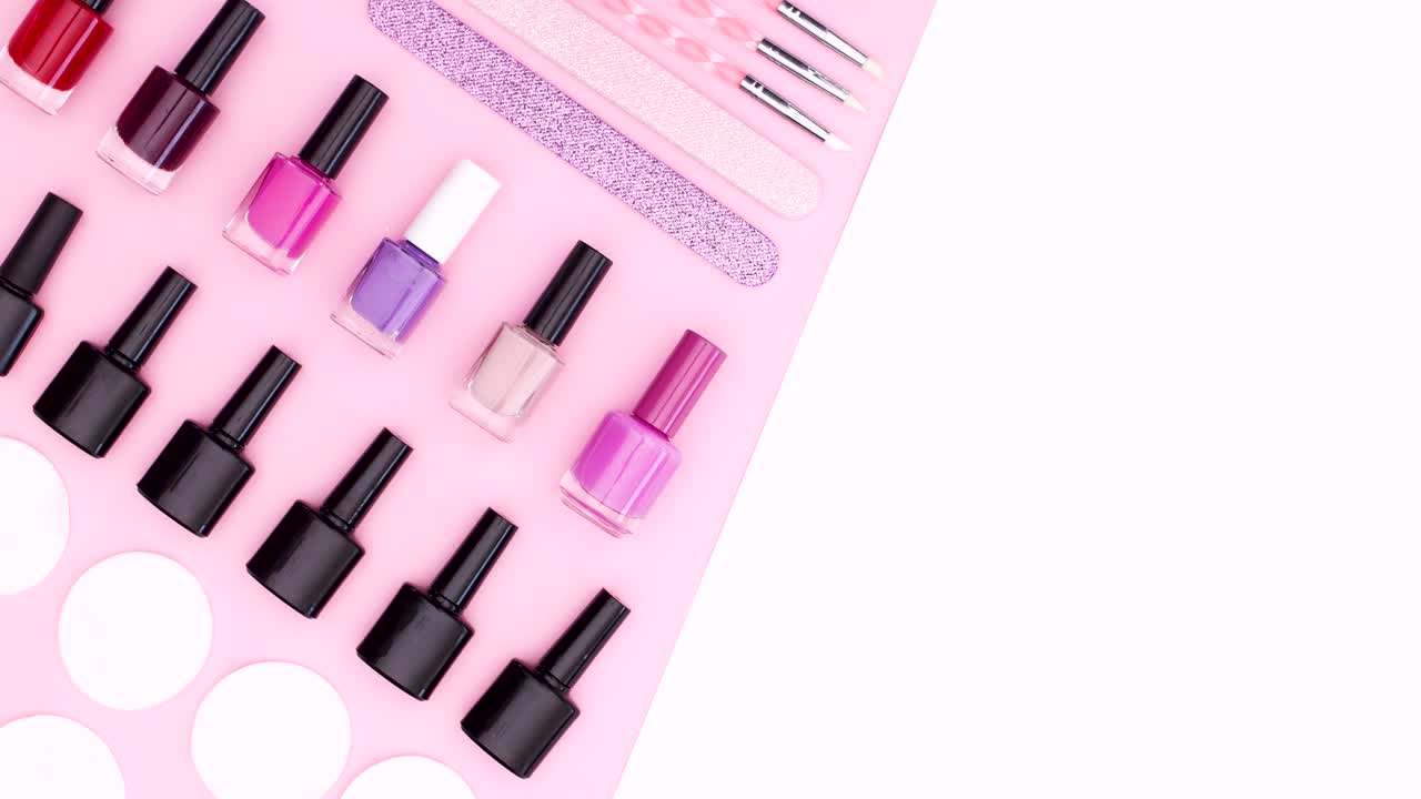 Nail gel polishes and manicure tools appear on pink white theme. Stop motion