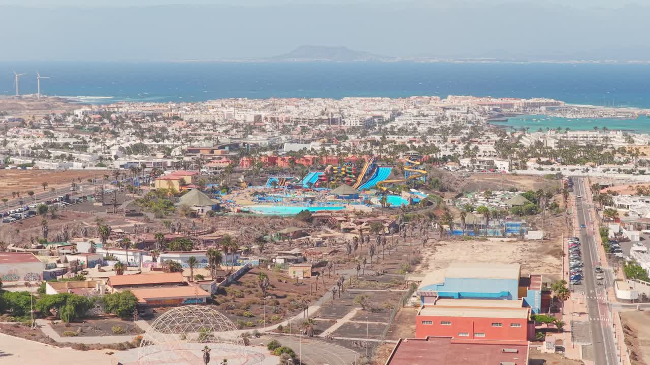 Aerial view of Acua Water Park in Corralejo, Fuerteventura, showcasing colorful slides, pools, and coastal surroundings in a popular Canary Islands destination