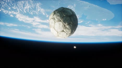 old soccer ball in space on earth orbit