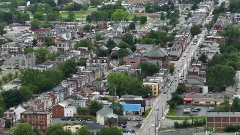 traffic on main street of american town with long row of houses in neighborhood