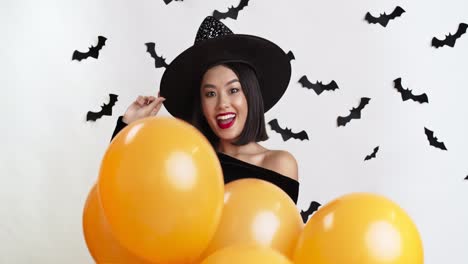 woman in witch costume with halloween decorations