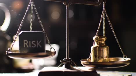 a close-up view of a scale balancing a block labeled risk against a golden weight labeled reward. this reflects the importance of weighing choices carefully in difficult situations.