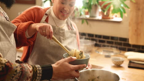 couple cooking pasta together in the kitchen