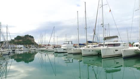 port with pleasure boats and catamaran with a view in the background of the castle of denia alicante