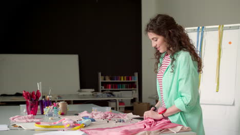 dressmaker cutting fabric.