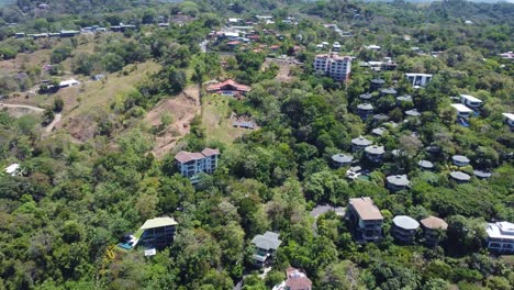 Stunning-aerial-footage-about-the-beauty-of-Manuel-Antonio,-a-city-in-Costa-Rica,-surrounded-by-lush-green-trees-and-vegetation,-Costa-Rica